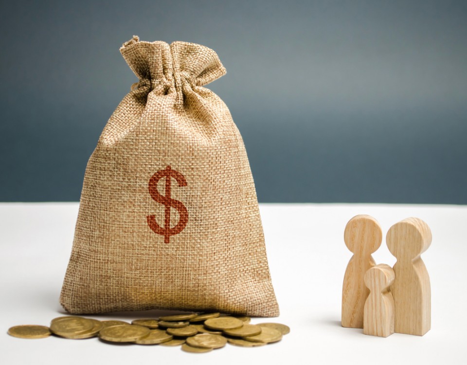 A money bag with a dollar sign is standing near the family. The concept of management a family budget. Profit and income. Savings and accumulation of money. Distribution of money and investment.